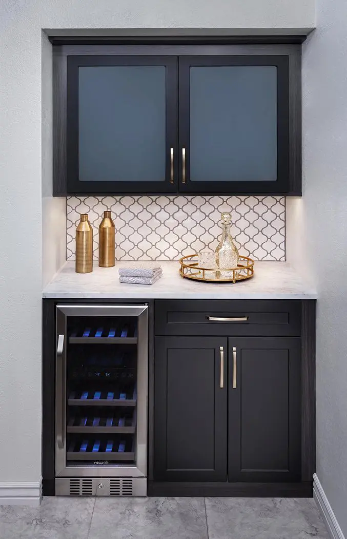 A wine cooler in a black cabinet.