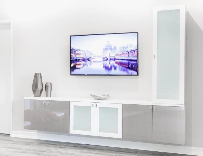 A modern living room with a tv mounted on the wall.