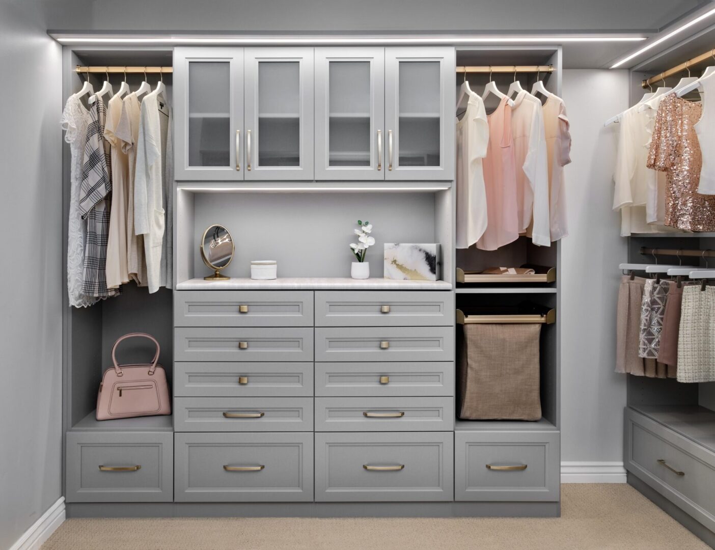 A walk in closet with clothes and drawers.